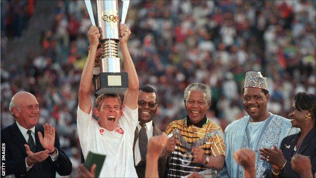 South Africa's winning captain of the 1996 Africa Cup of Nations Neil Tovey lifts the trophy in Johannesburg