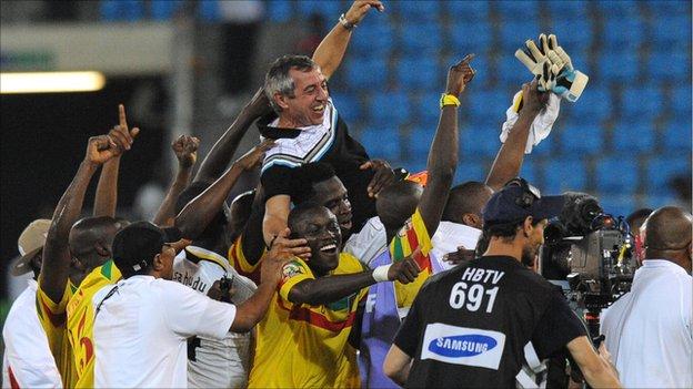 Mali coach Alain Giresse is given the bumps by his delighted squad