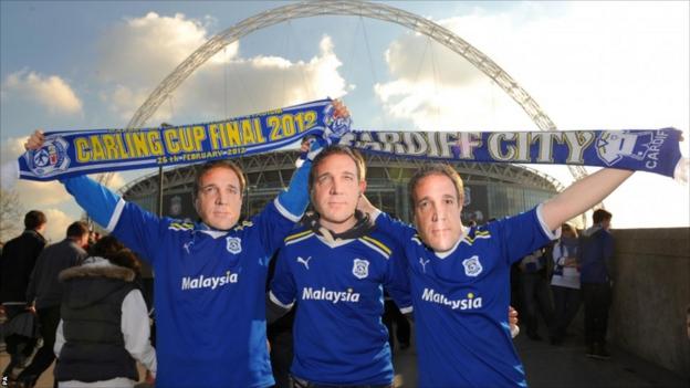 Cardiff City fans wearing masks of Cardiff City Manager Malky Mackay outside Wembley Stadium, before the Carling Cup Final at Wembley Stadium