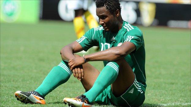 John Mikel Obi reacts to Nigeria's failure to reach the 2012 Africa Cup of Nations following a 2-2 draw against Guinea in Abuja