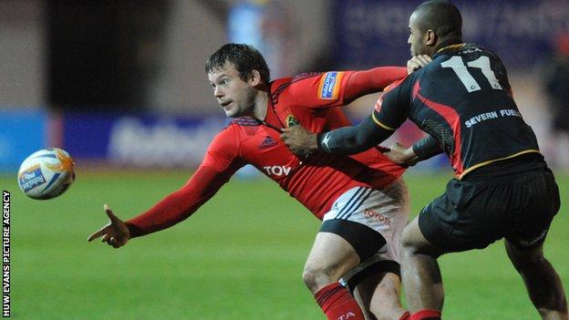Munster's Denis Fogarty is tackled by Aled Brew