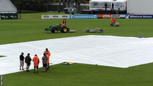 The Dunedin pitch is covered as rain falls