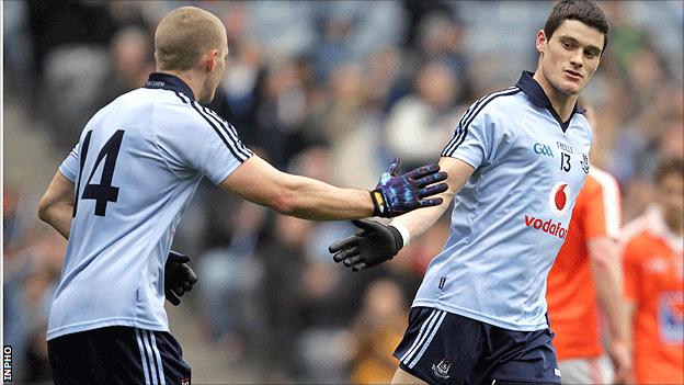 Eoghan O'Gara congratulates Dublin scorer Diarmiud Connolly