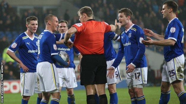 Cardiff City players surround the referee after Ben Turner's disallowed goal
