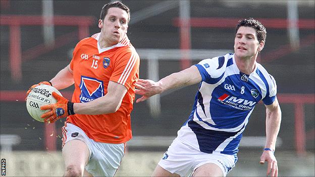 Armagh's Gavin McParland on the ball as Brendan Quigley of Laois moves in to challenge