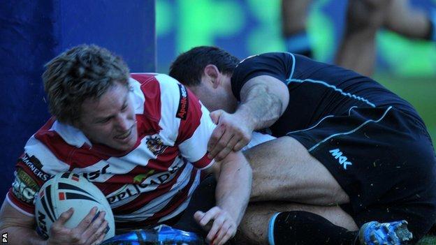 Wigan Warriors' Brett Finch is tackled by London Broncos' Chad Randall but still scores a try