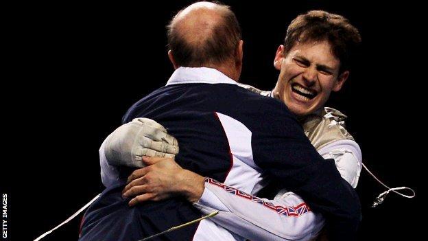 Richard Kruse hugs his coach at the Olympic test event