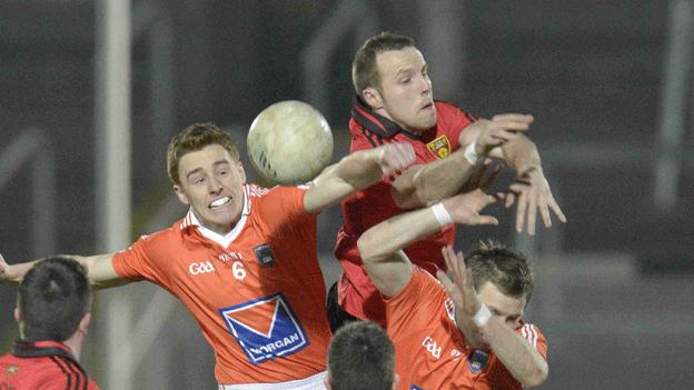 Armagh's Charles Vernon contests the high ball with Ambrose Rogers