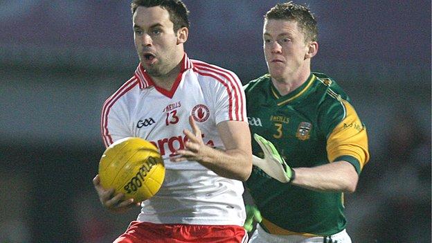 Tyrone's Kyle Coney is challanged by Kevin Reilly