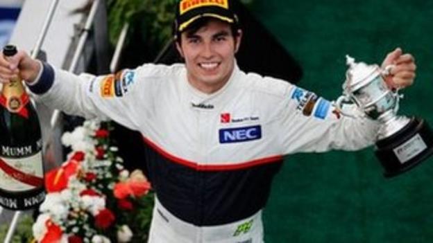 Sergio Perez of Mexico and Sauber F1 celebrates on the podium after finishing second during the Malaysian Formula One Grand Prix at the Sepang Circuit