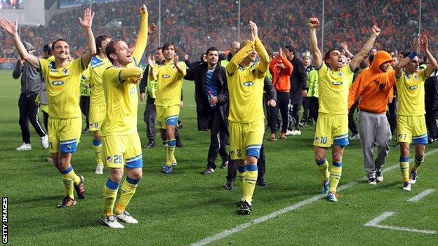 Apoel Nicosia players celebrate after their victory over Lyon in the Champions League