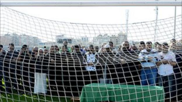 Al-Masry fans pray behind the coffin of Belal Mamdouh, the 13-year-old boy who died on Friday