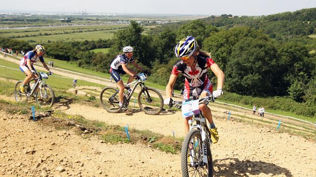 Catharine Pendrel (gold) of Canada leads Julie Bresset (bronze) of France and Georgia Gould (silver) of the USA at the women's mountain biking test event at Hadleigh Farm on 31 July 2011
