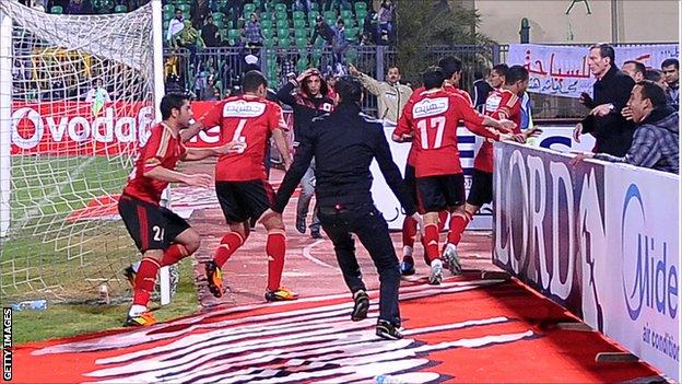 Al Ahly players head from the field during the match against Al Masry