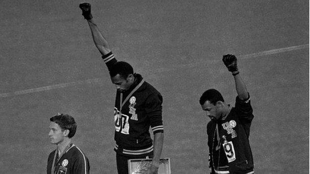 Tommie Smith, centre, and Jon Carlos, right, on the podium at the 1968 Olympics