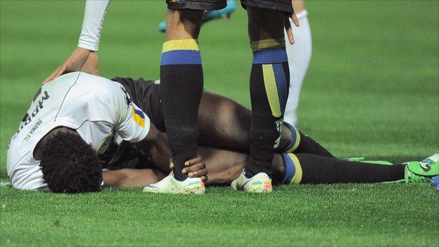 Kenya and Parma's McDonald Mariga lying injured on the pitch