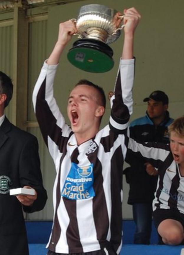 Mark McGrath lifts the Guernsey FA Cup
