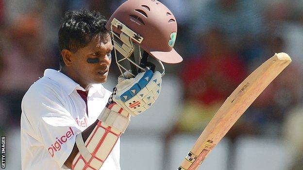 Shivnarine Chanderpaul lifts his helmet after reaching 10,000 Test runs