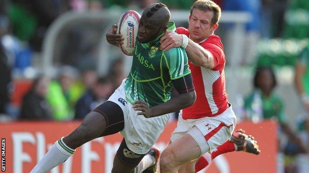 Jamba Ulengo of South Africa is tackled by Ifan Evans of Wales