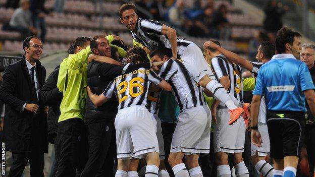 Juventus celebrate scoring against Cagliari - their win sealed the Serie A title