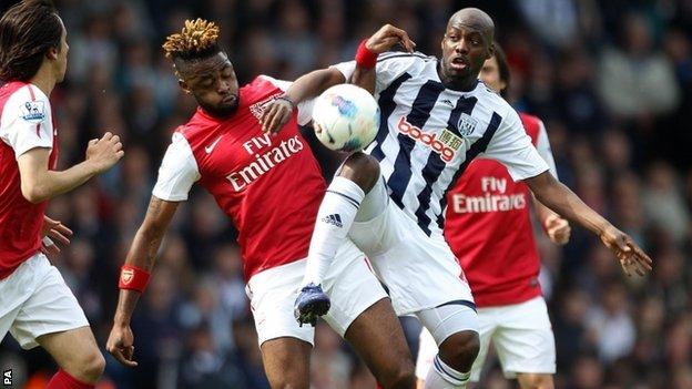 Arsenal and West Brom battle for the ball
