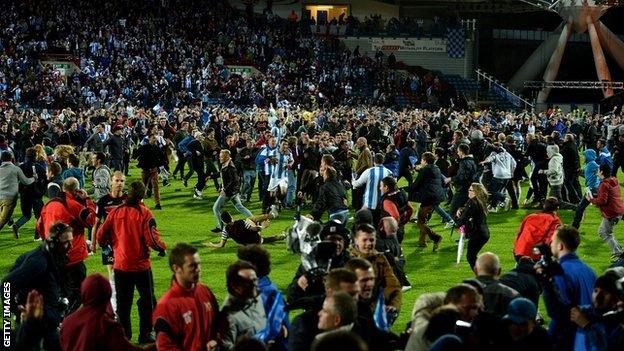 Huddersfield Town fans invade the pitch