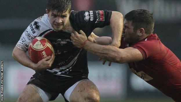Pontypridd's Lewis Jones is caught by Llanelli's Kirby Myhill