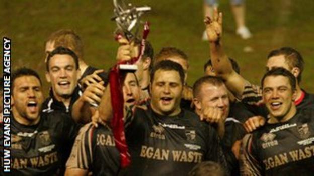 Pontypridd captain Chris Dicomidis lifts the Premiership trophy