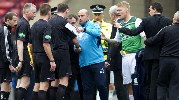 Hibs players and management confront the officials at the final whistle