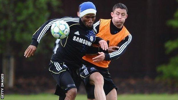 Gary Cahill (right) takes on Didier Drogba in training