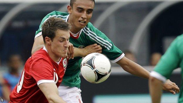 Aaron Ramsey holds off Mexico's Jesus Zavala during the 2-0 defeat in New Jersey