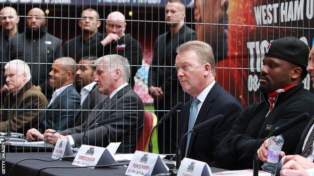 Dereck Chisora, Frank Warren and David Haye sit amongst others at the fight press conference at Upton Park
