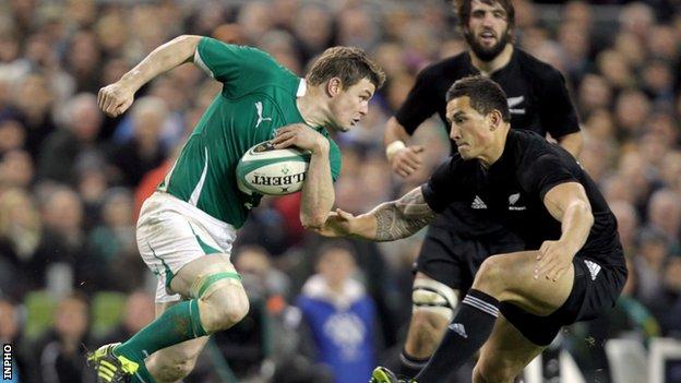 Brian O'Driscoll is about to be tackled by Sonny Bill Williams in 2010