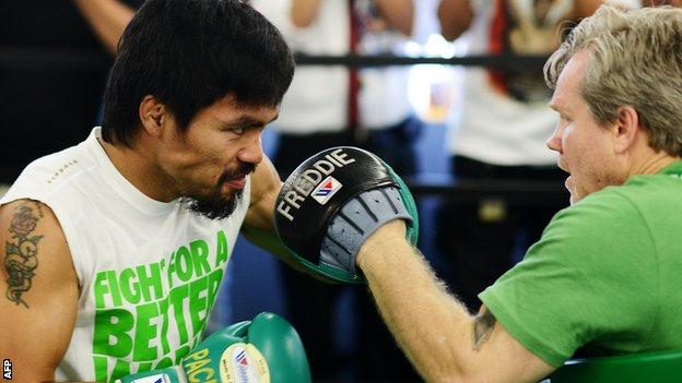 Manny Pacquiao spars with trainer Freddie Roach ahead of his fight with Timothy Bradley
