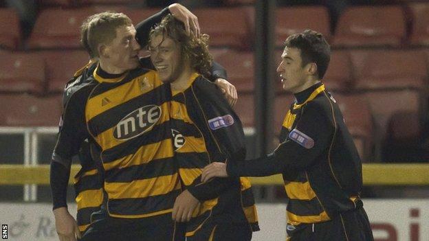 May (centre) celebrates scoring a goal while on loan with Alloa