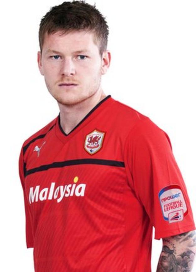 Aron Gunnarsson models Cardiff's new red kit