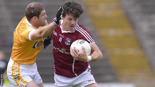 Antrim's Tony Scullion challenges Sean Armstrong of Galway