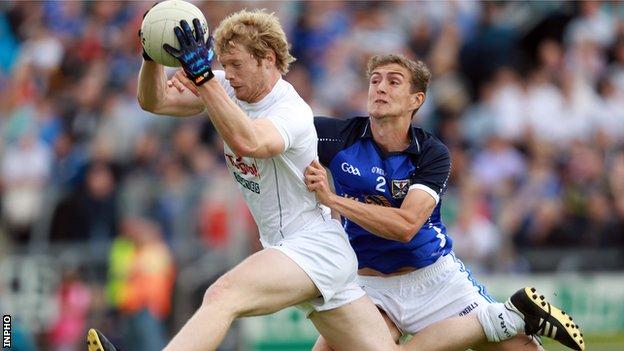 Tomas O'Connor of Kildare catches the ball as Killian Clarke of Cavan challenges