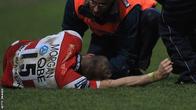 Olly Morgan receives medical attention in the game against Worcester Warriors
