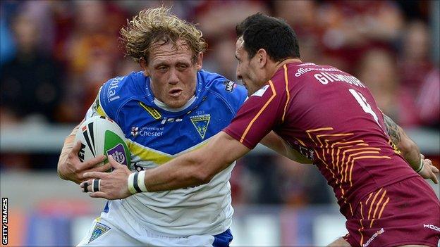 Warrington's Ben Westwood is tackled by Lee Gilmour of Huddersfield