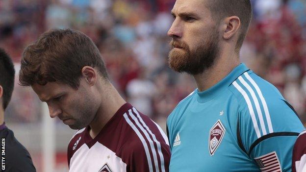 Colorado Rapids' Drew Moor and Matt Pickens pause for a moment of silence in honour of the shooting victims in Aurora, Colorado before a game against Real Salt Lake on Saturday, 21 July 2012 at Rio Tinto Stadium in Sandy, Utah
