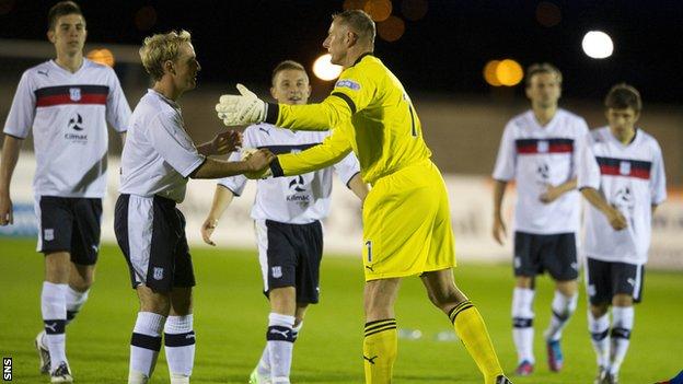 Douglas (centre) was the hero for Dundee in the penalty shoot-out