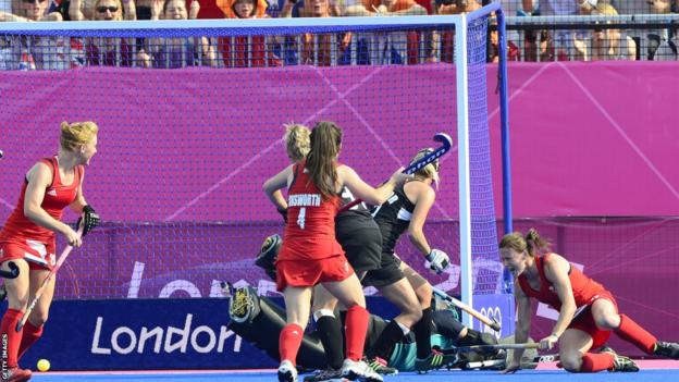Sarah Thomas (R) scores Team GB's third goal in a 3-1 hockey win against New Zealand, a victory that secured a bronze medal for Great Britain