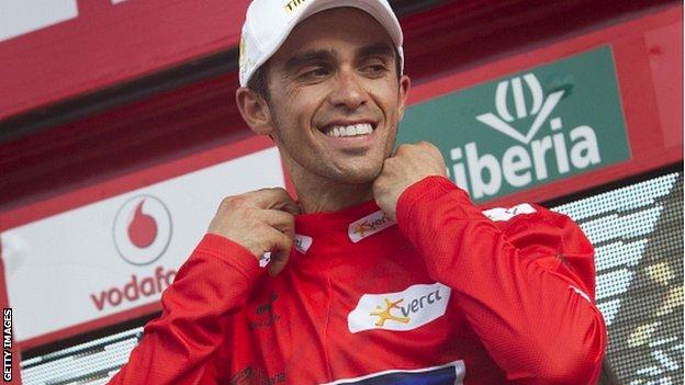 Alberto Contador slips on the leader's red jersey for the third day in a row