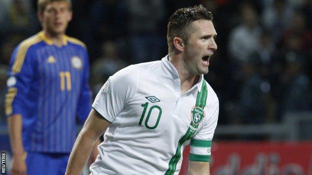 Robbie Keane celebrates after scoring his penalty in Astana