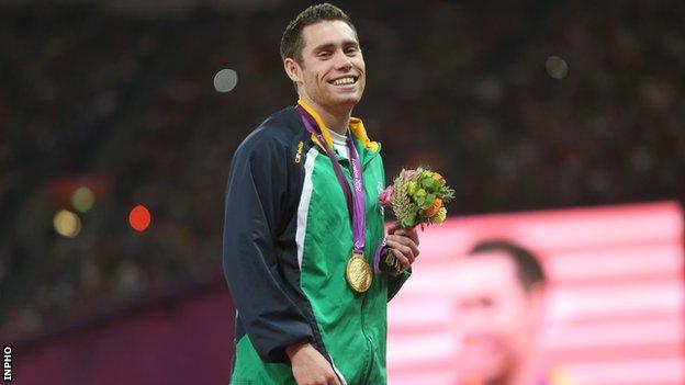 Jason Smyth smiles after being presented with his second London Paralympics gold by Lord Coe