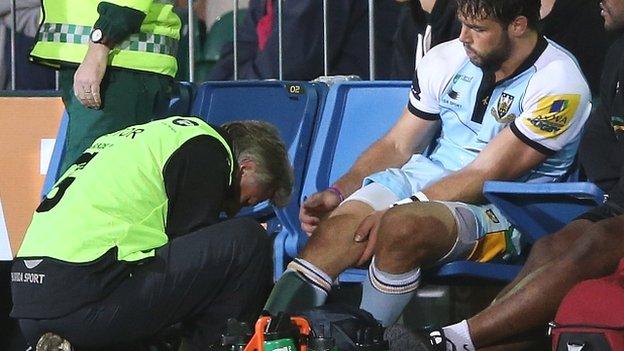 Ben Foden receives treatment after suffering an ankle injury