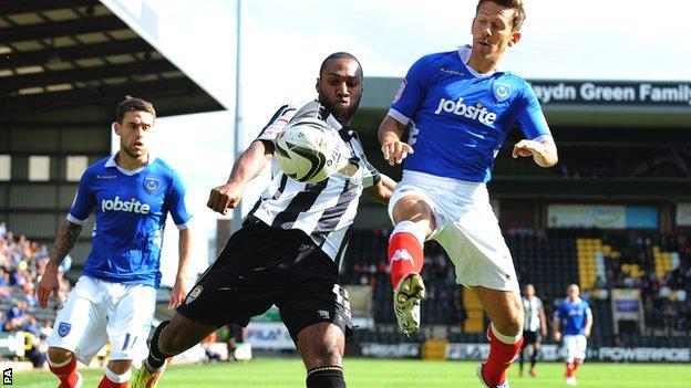Yoann Arquin (left) is challenged by Portsmouth's Jon Harley