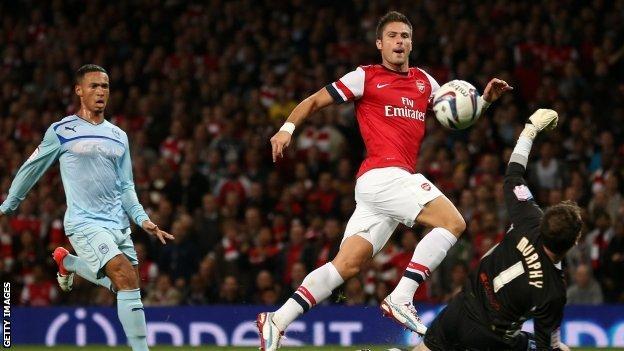 Olivier Giroud of Arsenal scores their first goal during the Capital One Cup third round match between Arsenal and Coventry City