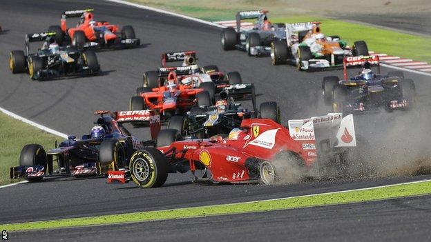 Ferrari driver Fernando Alonso of Spain spins off the track at the start of the Japanese Formula 1 Grand Prix at the Suzuka Circuit